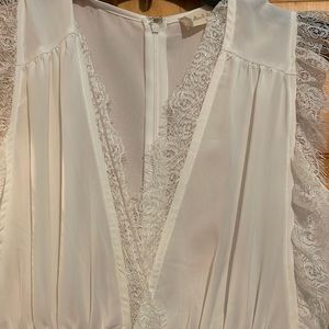 Beautiful white jumpsuit with lace neckline detail.